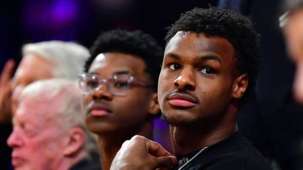 Bronny James and Bryce Maximus watch their father Los Angeles Lakers forward LeBron James (6) play in the third quarter against the Oklahoma City Thunder at Crypto.com Arena.